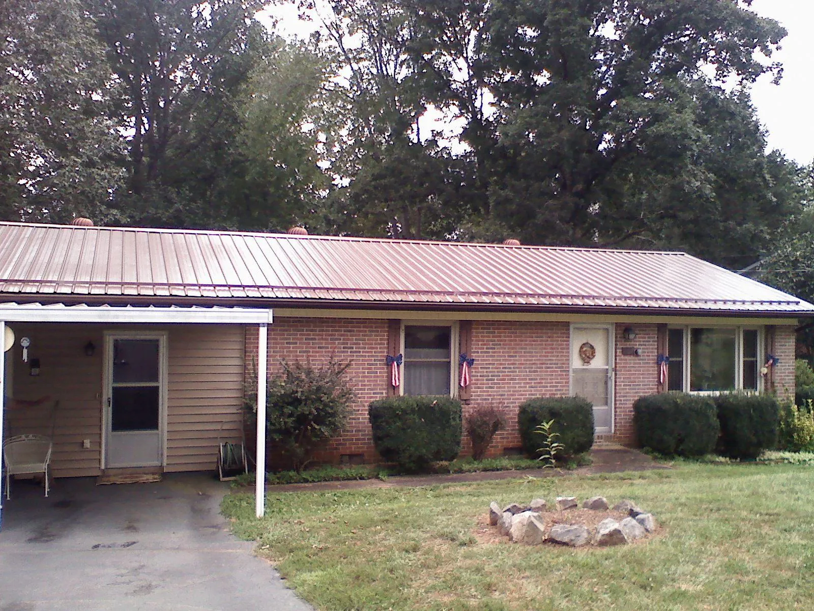 Bronze metal roof and carport on a brick ranch home — Roof Repair work by our crew in Tabor