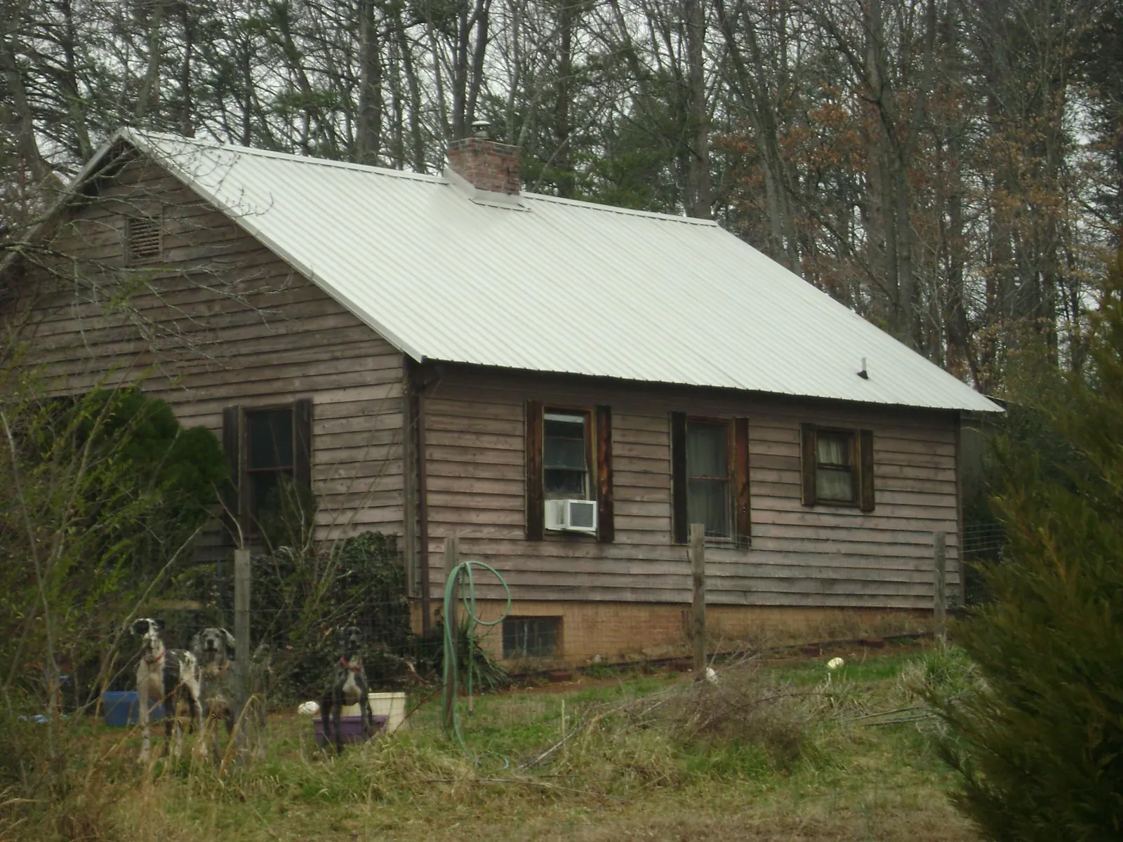 White metal roof on an old wood sided farmhouse, from a Metal Roof Installation job in Tabor